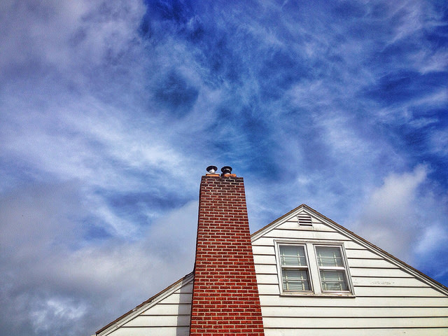 house with chimney and blue sky